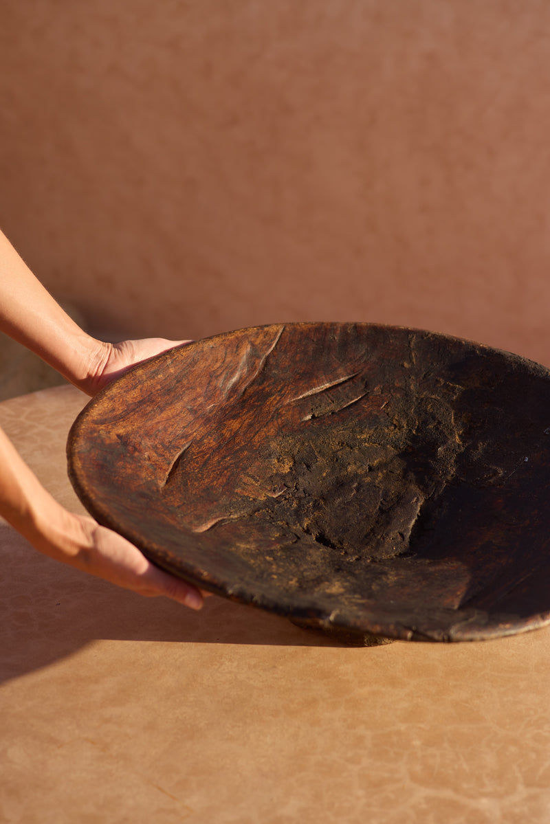 Moroccan walnut couscous bowl — underside view showing wear and repair.