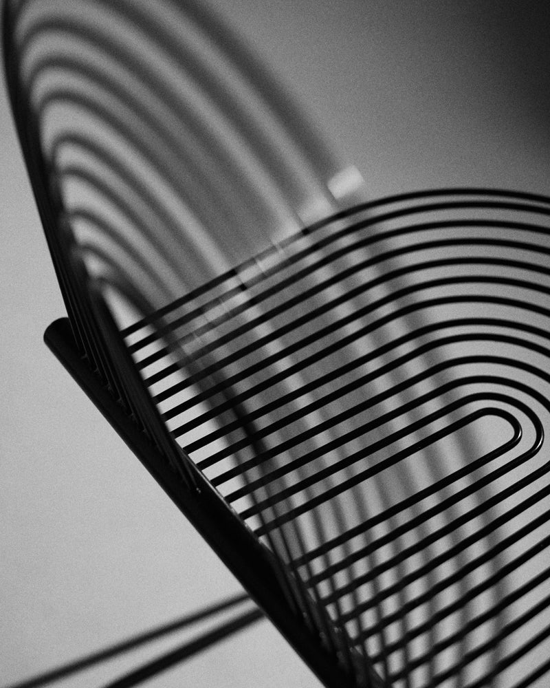 Swing chair — sprung steel seat detail, black finish.