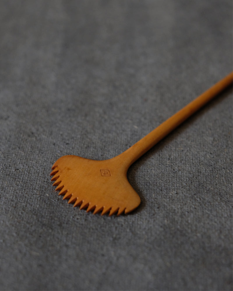Close-up of rounded carved edge on Japanese maple wood comb