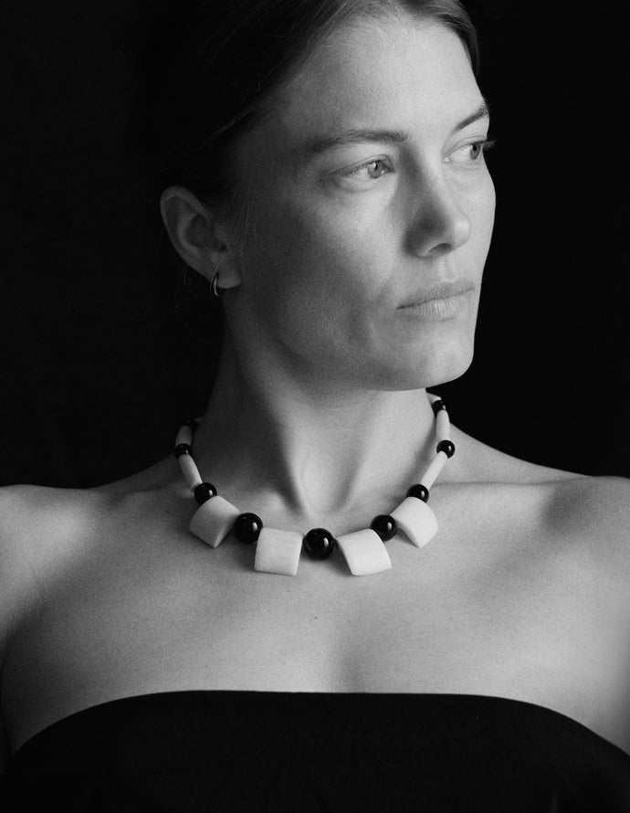 Carved bone and bead necklace, 20th century — worn on body.