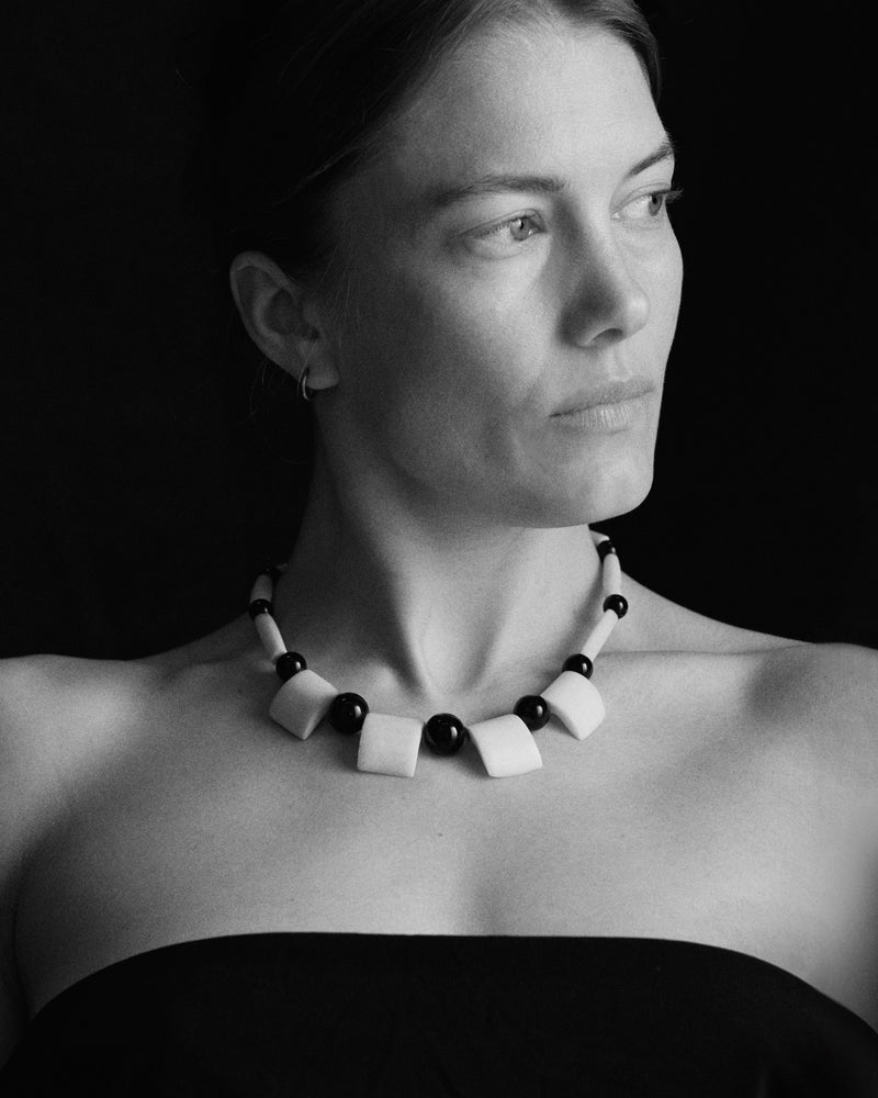 Carved bone and bead necklace, 20th century — worn on body.
