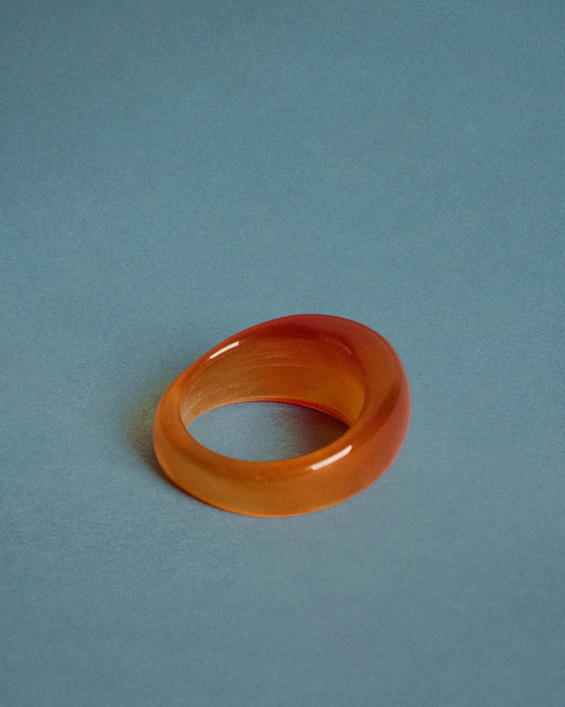 Amber onyx ring — angled view, translucent amber tone.