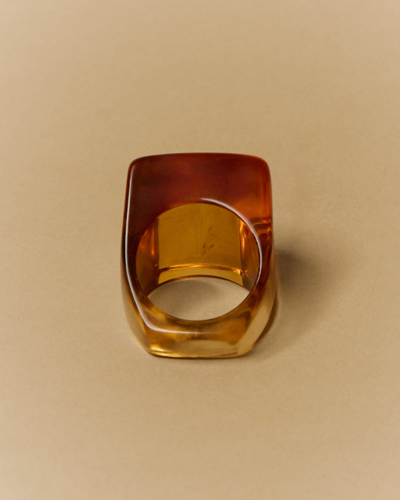 Amber resin ring, 20th century — angled view showing internal patterning.