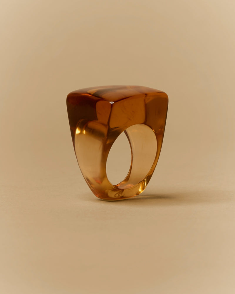Amber resin ring, 20th century — front view, polished amber tone.