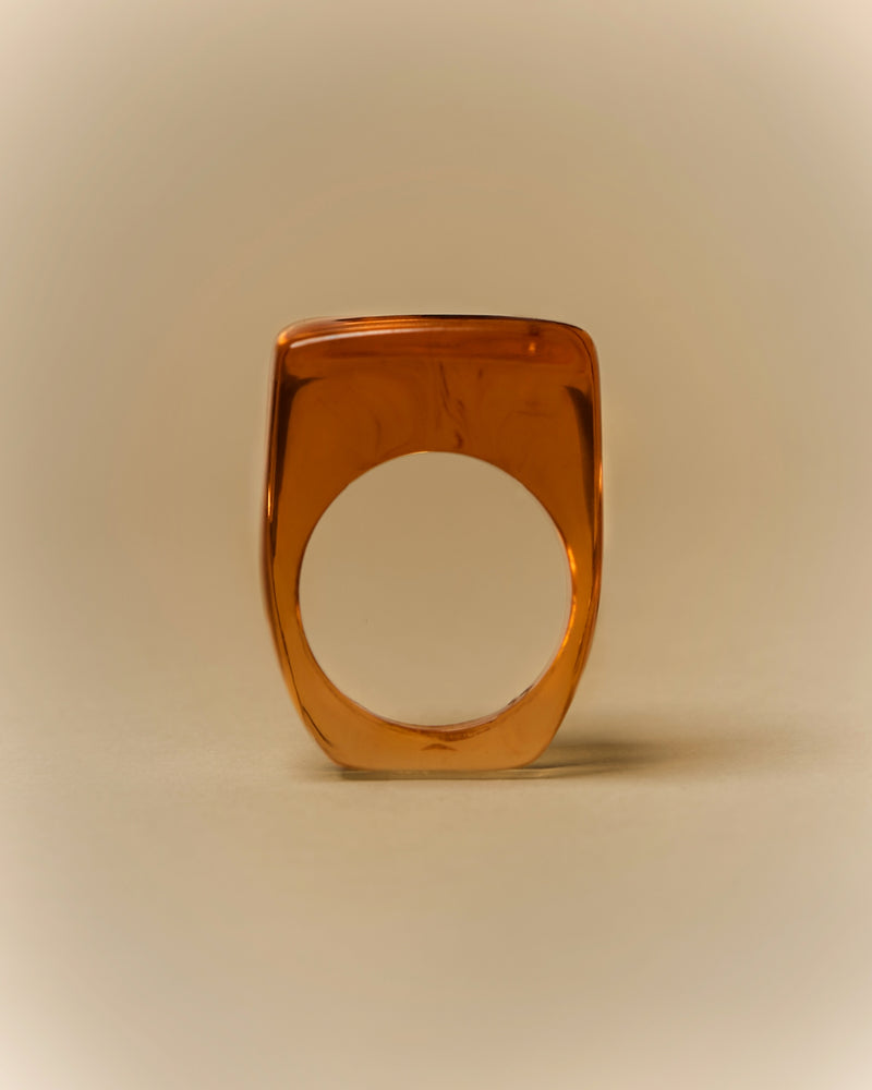 Amber resin ring — side profile, square form.
