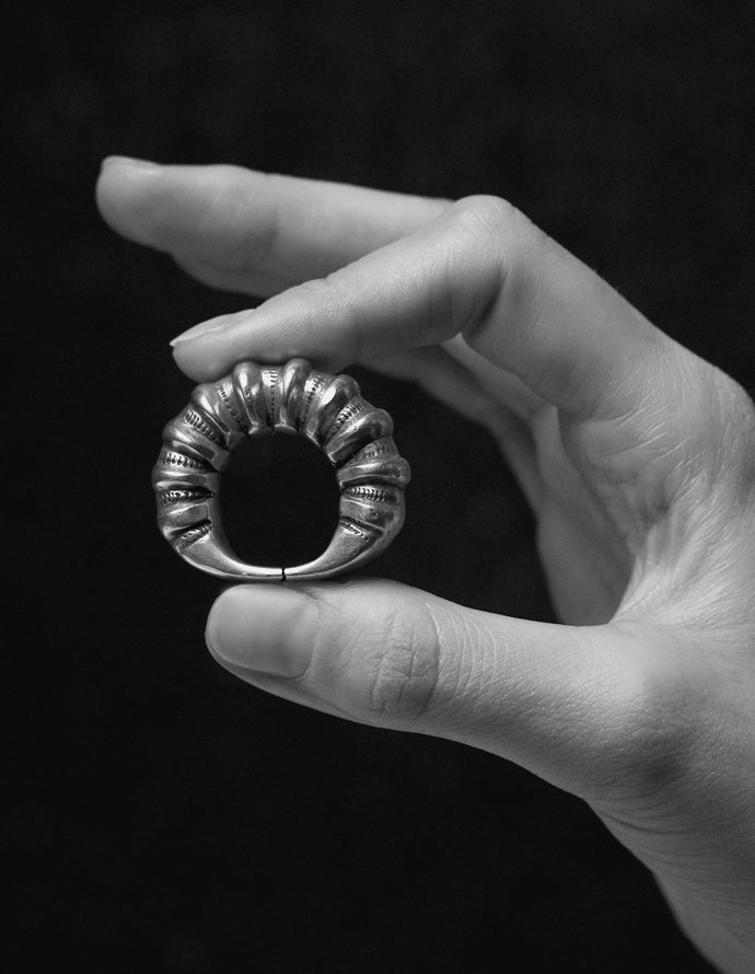 Berber (Amazigh) silver ring, Draâ Valley — held in hand, Tifinagh markings.