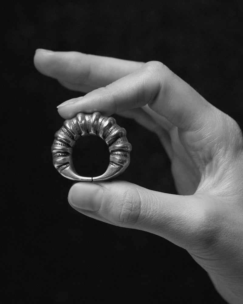Berber (Amazigh) silver ring, Draâ Valley — held in hand, Tifinagh markings.