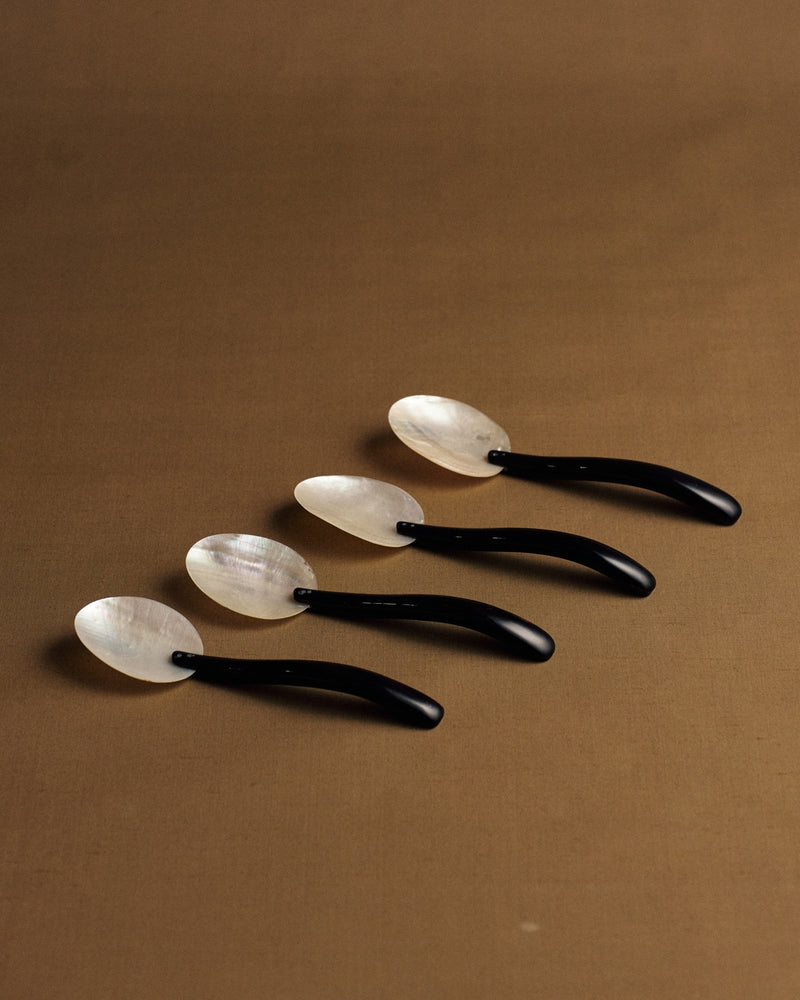 Mother of pearl and Bakelite spoons — angled view, Italian set of four.